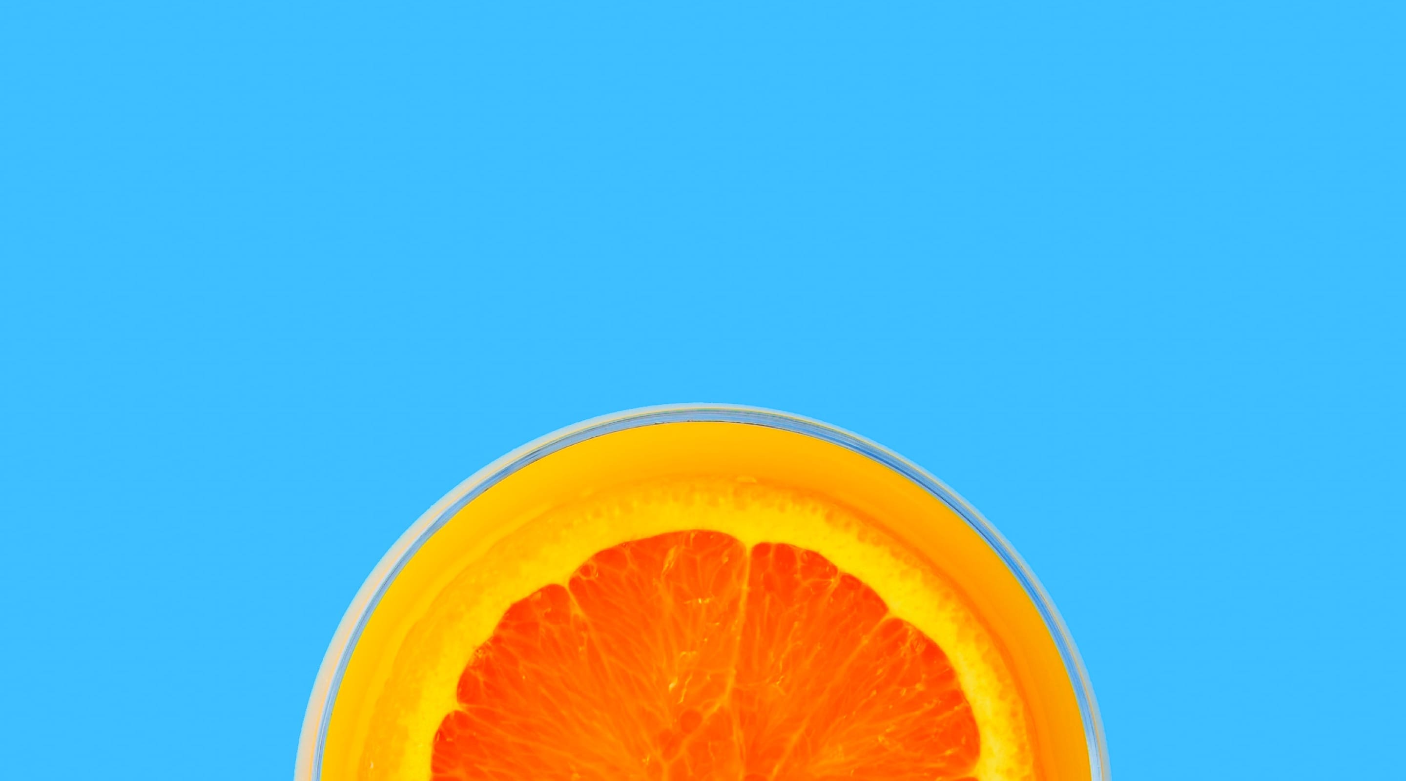 header image of an orange slice on a blue background